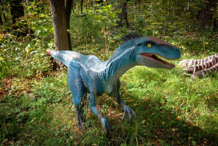 Realistic Velociraptor Dinosaur in Forest Setting
